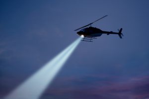 Police helicopter with strong searchlight.