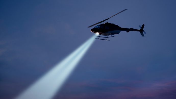 Police helicopter with strong searchlight.