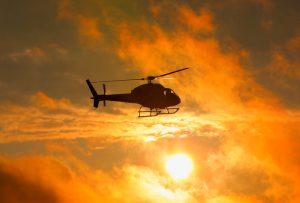 Silhouette of military helicopter at sunset